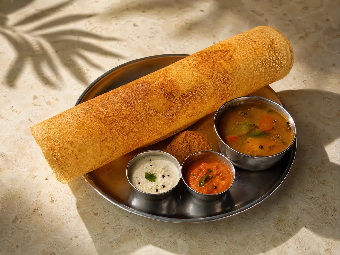 A crisp masala dosa with chutneys and sambar.